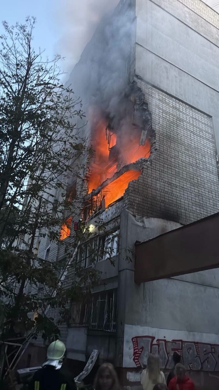 Fire and smoke pour from an apartment building struck during the overnight missile attack.